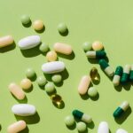 colorful-pills-and-capsules-on-green-background-royalty-free-image-1724687998.jpg